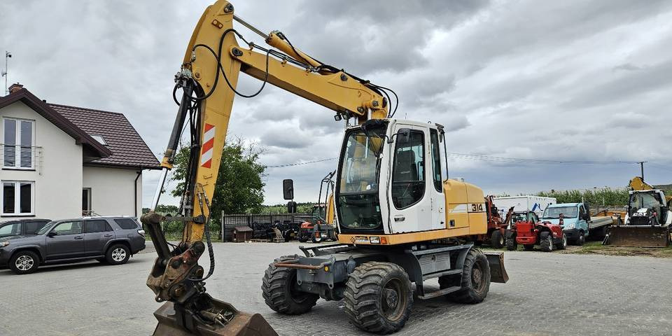 Koparka kołowa Liebherr A314 Litronic 9350 h 4 łyżki kołówka - Kolesové rýpadlo: obrázok 2 Koparka kołowa Liebherr A314 Litronic 9350 h 4 łyżki kołówka - Kolesové rýpadlo: obrázok 2